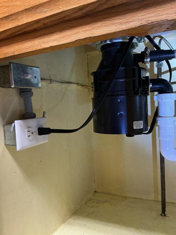 Removed the existing garbage disposal and installed a new Badger Five 1/2 HP unit, reconnecting it to the drain assembly with a rubber elbow fitting and hose clamp. Restored the electrical connection to the existing switched outlet and verified the P-trap connections were secure and the unit operated properly.