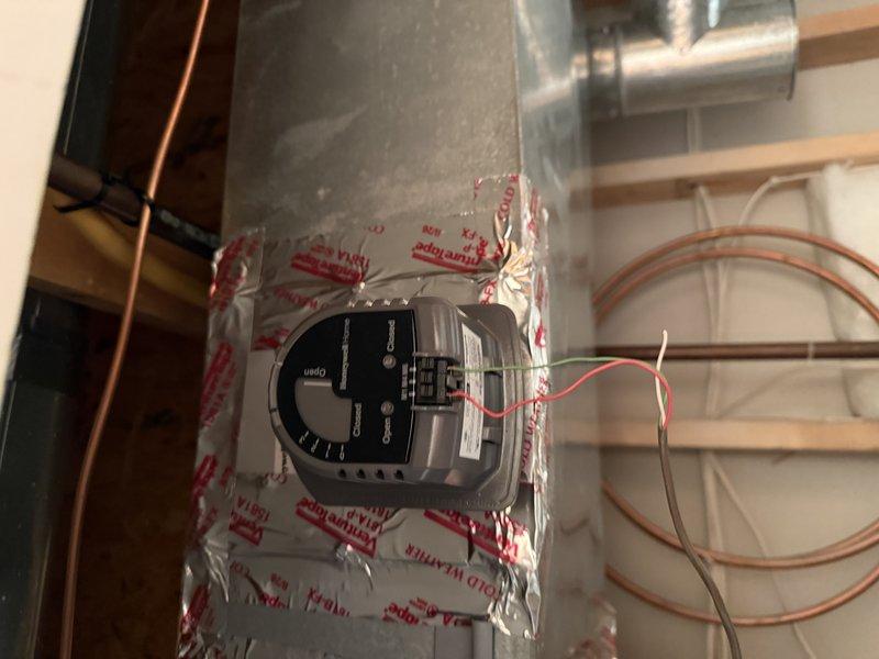 Installed zone damper actuators on the supply ductwork and connected the low-voltage control wiring to the zone control system. Also ran a copper water supply line with a brass compression-fitting shutoff valve to the humidifier. Verified damper operation and secure connections upon completion.