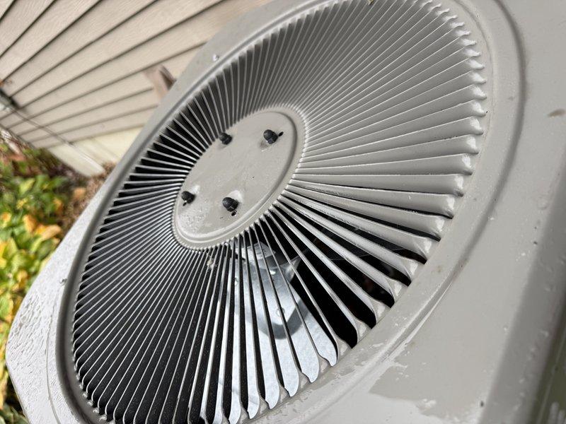 Replaced the failed condenser fan motor on the outdoor AC unit under warranty and installed the new motor, restoring proper condenser airflow. The fan assembly and guard were reinstalled and secured, with the unit's exterior surfaces and fan blade inspected and in good condition.