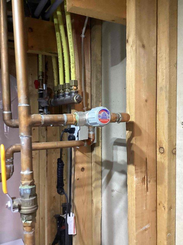 Diagnosed insufficient hot water complaint on a gas tank-type water heater and found both the gas control valve thermostat and the thermostatic mixing valve set to their lowest temperature settings. Set the gas control valve to the "A" setting and increased the thermostat and mixing valve temperature settings to restore proper hot water output. No defective components were found; the issue was resolved through adjustment.