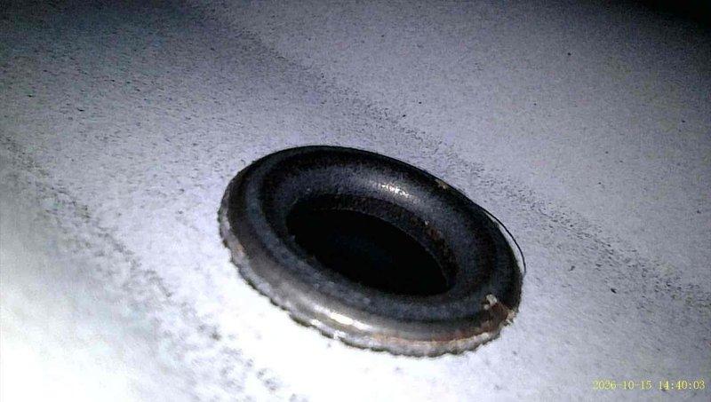 Responded to a no-heat complaint and verified the thermostat and system were operating properly. Borescope inspection of the 10+ year-old furnace revealed a cracked eyelet at the heat exchanger, along with rust and corrosion around the port opening. Recommended heat exchanger or furnace replacement due to the compromised heat exchanger.