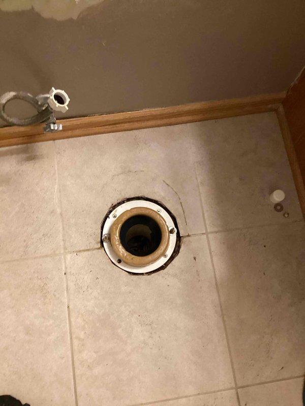 Traced a water leak in the laundry room to the hallway bathroom directly above, where the toilet was leaking at the base when flushed. Removed the toilet, installed a new wax ring and closet bolts, then reset and secured the toilet to the flange. Flushed multiple times to verify a proper seal, with no further leaks observed.
