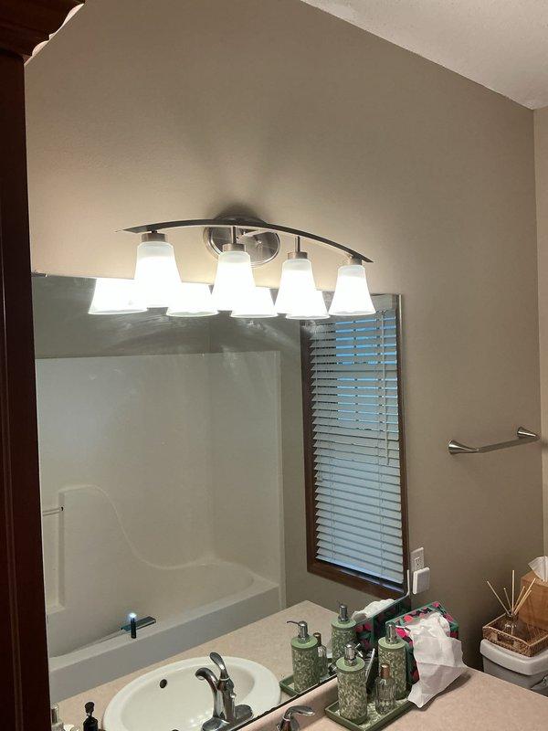 Installed dimmer switches, replaced an existing light fixture, mounted a new four-bulb vanity light fixture above the bathroom mirror, and installed two new receptacle outlets as part of a multi-room electrical project. All devices and fixtures were wired, secured, and tested for proper operation.