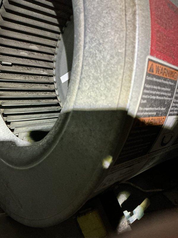Responded to a no-heat/no-cooling call and diagnosed a seized blower motor on the furnace/air handler, with condensation present around the unit; system was shut down to prevent further damage. Inspected the blower assembly and found dust accumulation on the blower wheel and housing, and the motor replacement under warranty and blower wheel cleaning are scheduled for the return visit.