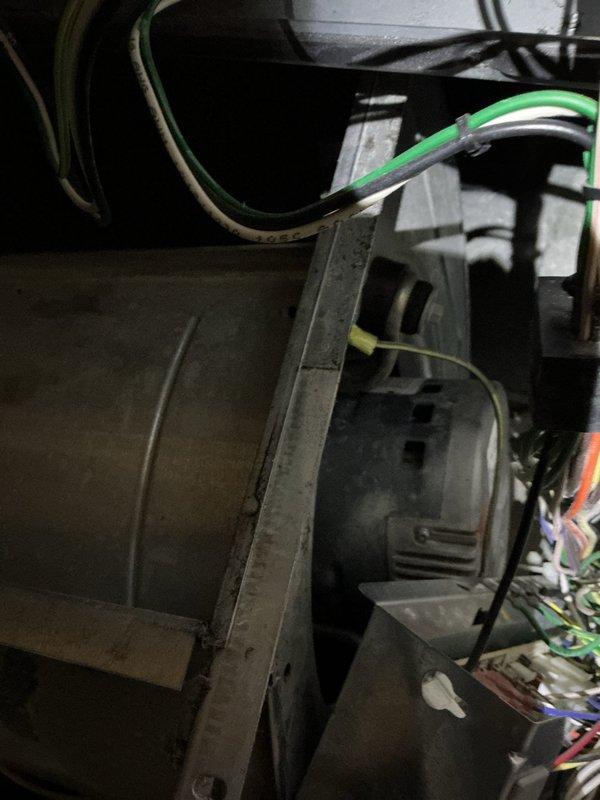 Responded to a no-heat/no-cooling call and diagnosed a seized blower motor on the furnace/air handler, with condensation present around the unit; system was shut down to prevent further damage. Inspected the blower assembly and found dust accumulation on the blower wheel and housing, and the motor replacement under warranty and blower wheel cleaning are scheduled for the return visit.