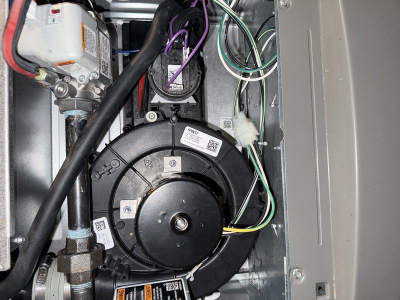 Responded to a no-heat call on a system under 10 years old and installed a replacement collector box on the induced draft assembly under warranty, using a part stocked from the shop. Following installation, inspected the inducer blower, pressure switch, gas valve, and associated wiring and found all components clean and free of visible damage, with condensate and venting connections intact.