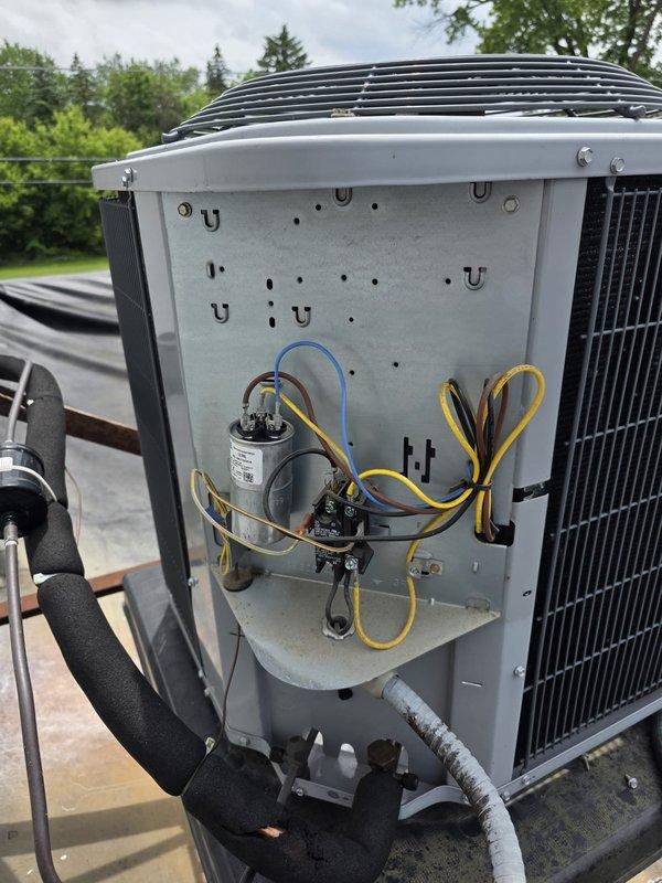 Responded to non-cooling complaint on 6-year-old Heil model N4A330GKG101 air conditioning unit located on rooftop. Upon arrival, confirmed unit was running with blower operational but no cooling output. Performed diagnostic evaluation by accessing electrical compartment and inspecting internal components including contactors, capacitor, and wiring connections. Verified equipment specifications and reviewed manufacturer documentation to ensure proper system operation parameters for this 2.5-ton residential air conditioner.