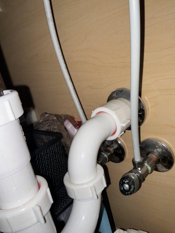Completed PLUM Member Check Up on residential property built in 2018. Verified Bradford White water heater model RG2PV50T6N (serial SE41501452), installed June 2018, currently 8 years old and operating within normal parameters. Inspected bathroom plumbing fixtures including sink faucet assembly, supply lines, shut-off valves, and drain trap configuration; all components found in good working condition with no leaks or deficiencies noted.