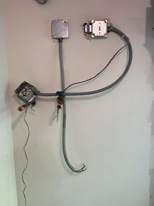 Successfully completed installation of Magic-Pak package unit model HWC848-7-11-24P-02A, serial number 1626D08728. Installed electrical conduit system with junction boxes, wiring, and proper connections to support unit operation. Verified all unit specifications, safety labels, and manufacturer certifications are properly displayed and accessible per code requirements.