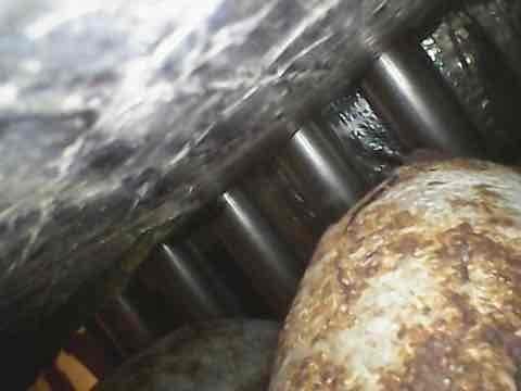 Responded to no cooling complaint on 20-year-old Armstrong Air package unit model 51HWC183A-3C. Upon inspection, found evidence of significant corrosion on evaporator coil components and refrigeration lines, indicating advanced age-related deterioration. Documented equipment condition with photographs showing rust and oxidation on critical components within the unit cabinet, which is likely contributing to system failure and refrigerant loss.