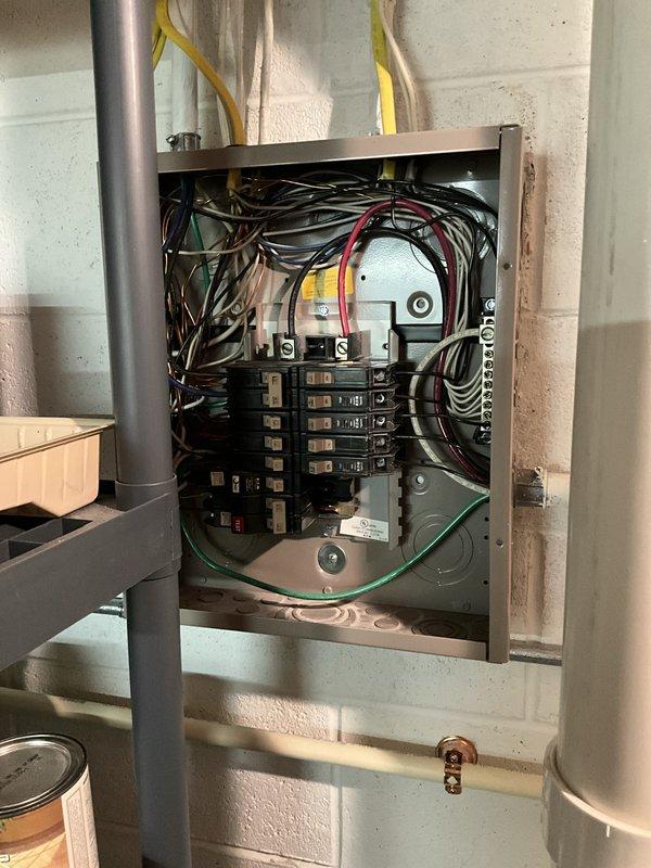 Completed ELEC Member Check Up on residential property built in 2007. Verified and documented three major equipment systems: two Trane air conditioning units (Model 4TTR3060A1000AA, 15 years old, and Model 4TTR3024A1000AA, 16 years old, both with expired manufacturer warranties on functional parts) and one Bradford White water heater (Model RG275H6N, 4 years old). Inspected electrical panel, noting standard residential circuit breaker configuration with visible rust staining at bottom interior indicating moisture exposure or age-related deterioration, and documented wire management conditions at panel entry points.