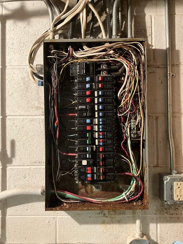 Completed ELEC Member Check Up on residential property built in 2007. Verified and documented three major equipment systems: two Trane air conditioning units (Model 4TTR3060A1000AA, 15 years old, and Model 4TTR3024A1000AA, 16 years old, both with expired manufacturer warranties on functional parts) and one Bradford White water heater (Model RG275H6N, 4 years old). Inspected electrical panel, noting standard residential circuit breaker configuration with visible rust staining at bottom interior indicating moisture exposure or age-related deterioration, and documented wire management conditions at panel entry points.