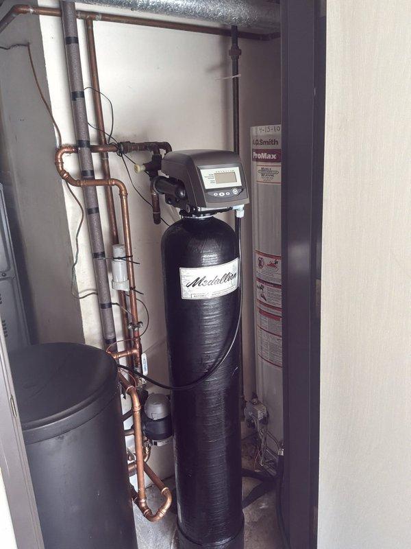 Completed installation of a 40-gallon Bradford White RG240T6N natural gas water heater with chimney venting in utility room. Removed and disposed of existing water heater equipment, temporarily relocated water softener system for access, and reinstalled upon completion. Installed new water supply piping with copper fittings, gas line connections with appropriate fittings and shutoff valve, and chimney vent piping to code specifications. Verified all connections for proper operation and leak-free performance, tested gas pilot and burner ignition sequence, and confirmed water heater is heating properly. Equipment is now operational with active 6-year manufacturer warranty on tank and parts, all work performed under permit.