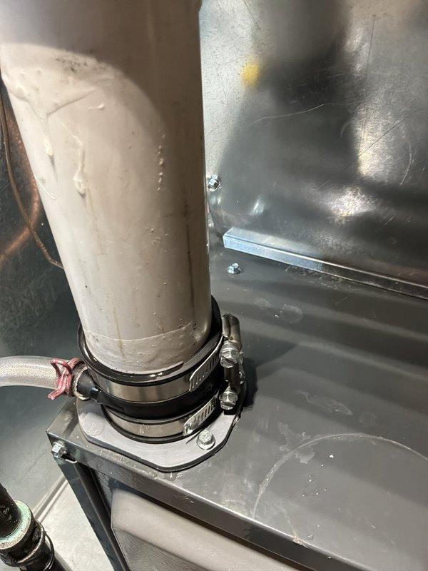 Responded to recall for moisture leaking from PVC venting pipe connected to Daikin furnace. Inspected condensate drainage system and PVC vent piping connections at furnace plenum, finding inadequate sealing at pipe penetration points causing recurring moisture infiltration. Re-secured PVC vent pipe with properly tightened hose clamps, resealed all pipe connections, and verified proper drainage slope to eliminate leakage issue.
