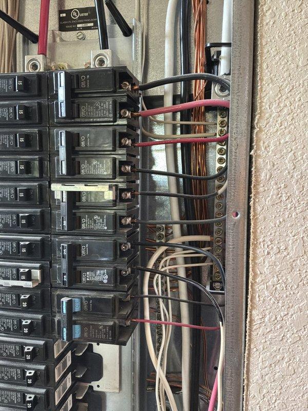 Performed comprehensive electrical panel inspection on 20-year-old residential system. Documented panel configuration showing dual-column circuit breaker arrangement with multiple branch circuits, neutral bus bar connections, and main service conductors. Photographed existing wiring conditions including mixed gauge conductors, bundled neutral wires, and terminal connections for service records. Customer updated via text with inspection findings.