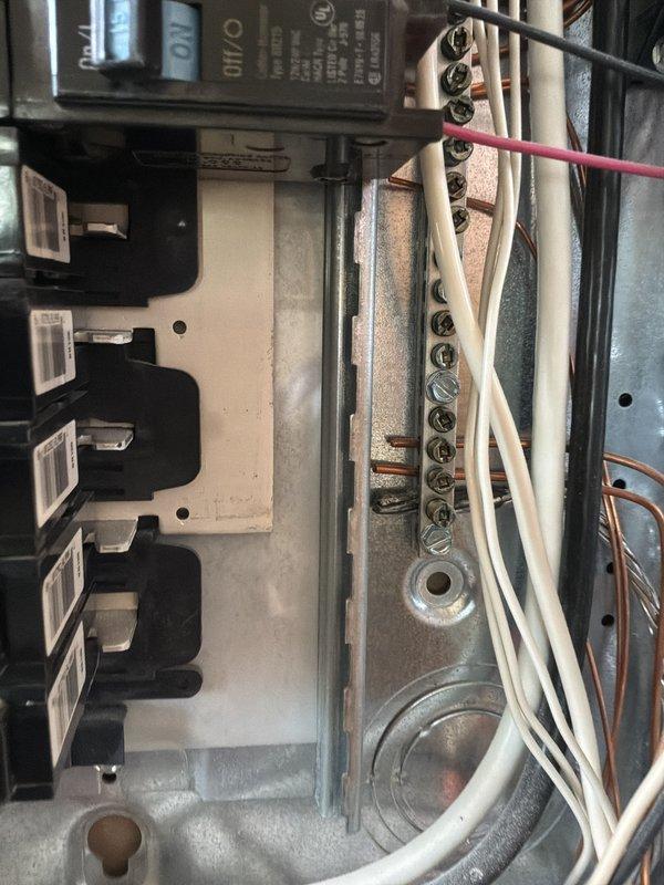 Performed comprehensive electrical panel inspection on 20-year-old residential system. Documented panel configuration showing dual-column circuit breaker arrangement with multiple branch circuits, neutral bus bar connections, and main service conductors. Photographed existing wiring conditions including mixed gauge conductors, bundled neutral wires, and terminal connections for service records. Customer updated via text with inspection findings.
