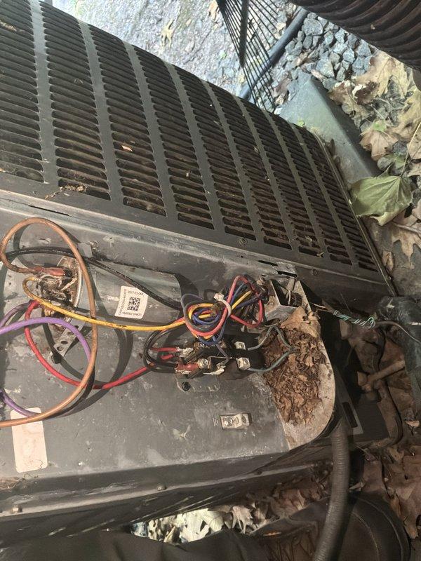 Responded to commercial no-cool call with no air blowing from air conditioning unit. Upon arrival, inspected outdoor condensing unit and found electrical control compartment heavily contaminated with dirt, leaves, and organic debris accumulation around contactor and wiring connections. Performed diagnostic evaluation of electrical components including contactor, wiring harness, and control circuits. Documented condition of equipment showing weathering, grime buildup on metal surfaces, and environmental debris infiltration in electrical compartment affecting system operation.