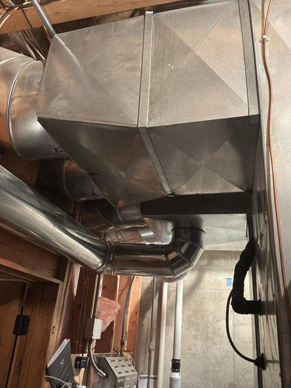 Responded to cooling concern in basement area where conditioned air was being delivered despite thermostat being in the off position. Inspected Armstrong Air furnace (Model G1D91AU100D20C-1A, 23 years old) and associated ductwork system serving the basement zone. Evaluated galvanized sheet metal plenum and flexible duct branches to identify which cooling equipment was actively serving the space and determined cause of unwanted air delivery when system should not be operating.
