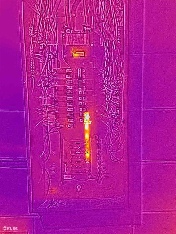 Performed comprehensive ELEC Member Check Up including visual and thermal imaging inspection of electrical system. Documented Rheem Professional water heater installation with proper plumbing connections, expansion tank, and electrical supply. Thermal imaging of electrical panel revealed elevated temperature signatures along central bus bar and circuit breaker connections, indicating potential high-resistance connections or overloaded circuits requiring monitoring or corrective action.