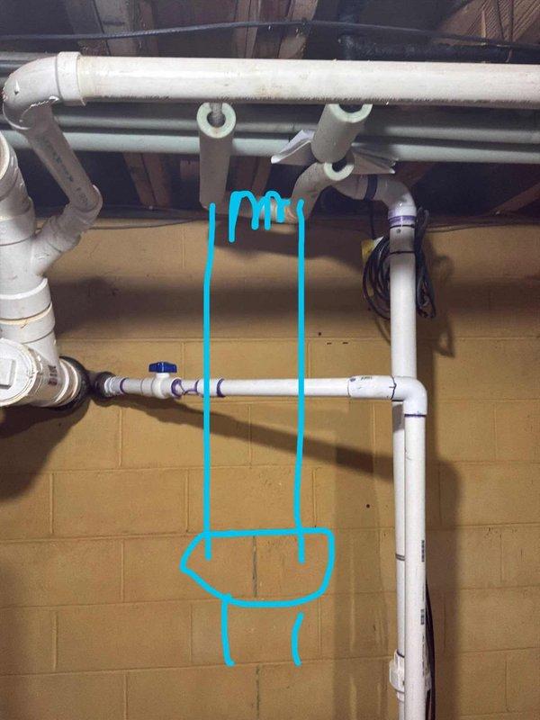 Conducted site assessment for water softener installation and potential iron curtain system in 1959 residential property. Evaluated existing plumbing infrastructure in basement utility area, including white PVC piping configuration along cinder block wall with blue shut-off valve. Documented primary water supply line routing from main to kitchen sink connection point. Assessed installation location near existing laundry facilities and floor drain for proper drainage capability. Discussed future reverse osmosis system integration planned for upcoming kitchen renovation project.