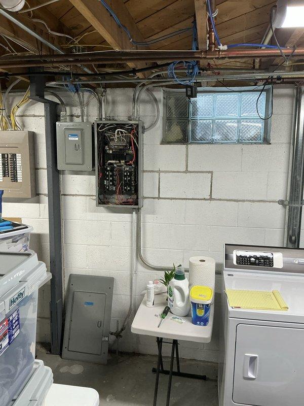 Conducted comprehensive site evaluation for standby generator installation at residential property. Performed detailed assessment of existing electrical infrastructure, including main service panel located in basement utility area. Documented current electrical system configuration, panel capacity, and available breaker spaces to determine generator interconnection requirements. Evaluated main service panel condition, noting significant corrosion, rust accumulation, and debris buildup on bus bar connections and interior components, indicating potential need for panel replacement or upgrade prior to generator integration. Assessed wire routing pathways, conduit locations, and transfer switch placement options in basement area near existing electrical equipment. Photographed electrical panel configuration showing 150-amp service with multiple circuit connections and aging wire insulation. Reviewed available space for automatic transfer switch installation and determined optimal location 