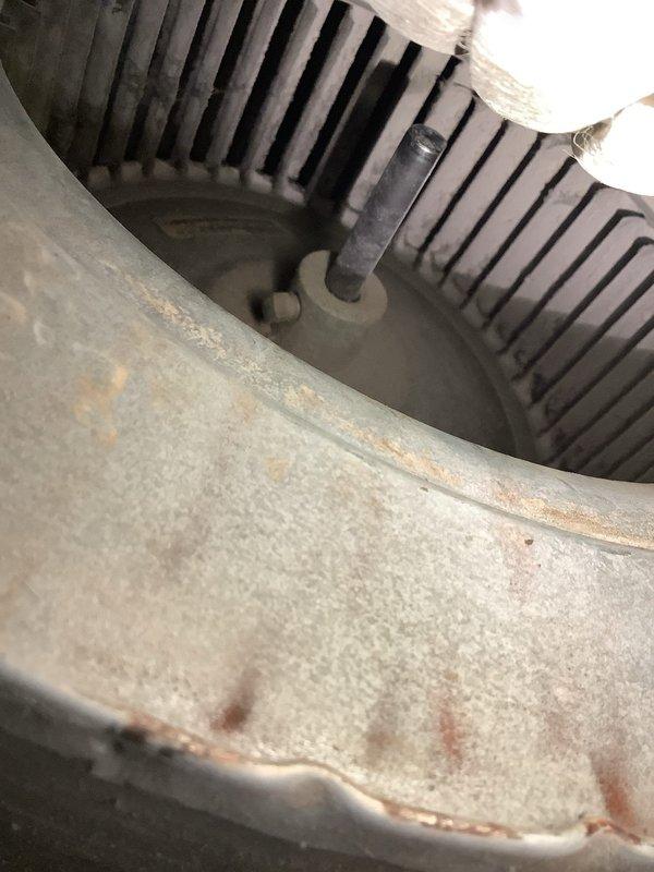 Responded to heating efficiency complaint on 2002 furnace system unable to reach thermostat setpoint. Upon inspection, discovered severely frosted evaporator coil and dirty blower assembly with significant rust and debris accumulation. Identified restricted airflow as primary cause due to clogged blower wheel and oxidized housing components. Documented conditions with photos showing heavy ice buildup on coil surfaces and contaminated blower wheel. Advised customer of findings and recommended complete system cleaning, blower motor evaluation, and potential ductwork assessment to restore proper airflow and heating capacity.