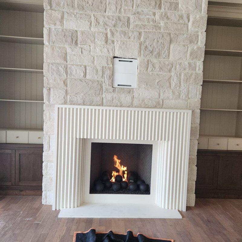 Responded to recall notice for fireplace unit. Retrieved fire balls from shop inventory and installed them in the firebox, arranging them properly on the decorative stone bed. Performed thorough cleaning of the unit and verified all components were functioning correctly. Successfully started the fireplace and confirmed proper ignition, flame pattern, and operation in preparation for scheduled home inspection.