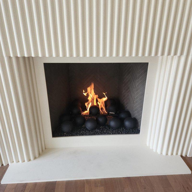 Responded to recall notice for fireplace unit. Retrieved fire balls from shop inventory and installed them in the firebox, arranging them properly on the decorative stone bed. Performed thorough cleaning of the unit and verified all components were functioning correctly. Successfully started the fireplace and confirmed proper ignition, flame pattern, and operation in preparation for scheduled home inspection.
