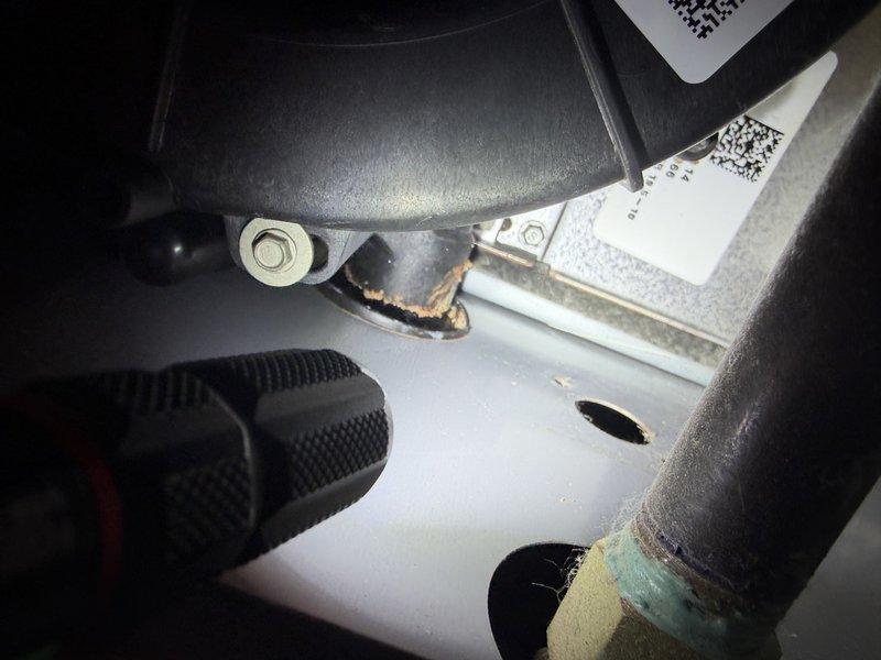 Responded to service call for Lennox furnace blower making abnormal noise during operation. Upon arrival, performed visual inspection of furnace unit located in interior mechanical closet. Conducted operational test of blower assembly while system was running. Identified source of noise as deteriorated blower motor mounting hardware showing signs of corrosion and wear at connection points. Inspected motor bearings, blower wheel balance, and mounting brackets for mechanical defects. Found corrosion present on mounting bolt assembly causing vibration and rattling during blower operation. Verified all electrical connections, refrigerant lines, and PVC venting pipes secure and properly installed. Confirmed furnace and AC system functioning within normal parameters despite noise issue. Documented condition with photographic evidence showing corroded mounting hardware and overall system configuration. Provided recommendations for blower motor mounting hardware replacement to eliminate noise 