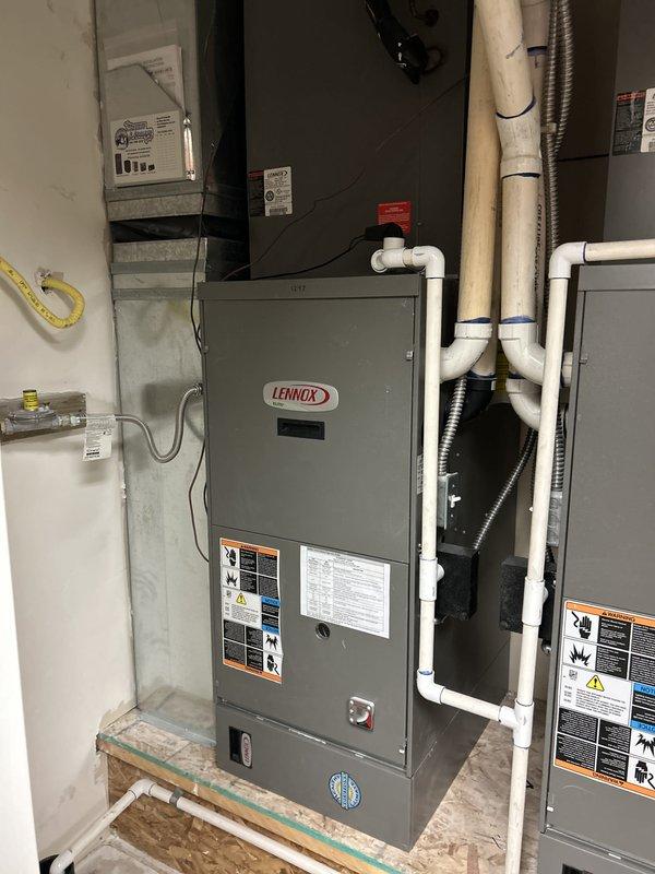 Responded to service call for non-operational north upstairs air conditioning unit in a dual-zone system with two 18-year-old Lennox units. Performed diagnostic evaluation on the affected north system, with indoor air handler located in accessible interior mechanical room and ground-level condenser unit. Documented equipment condition and system configuration through photographic records of the indoor unit installation and attic space components to support estimate preparation for necessary repairs or replacement recommendations.