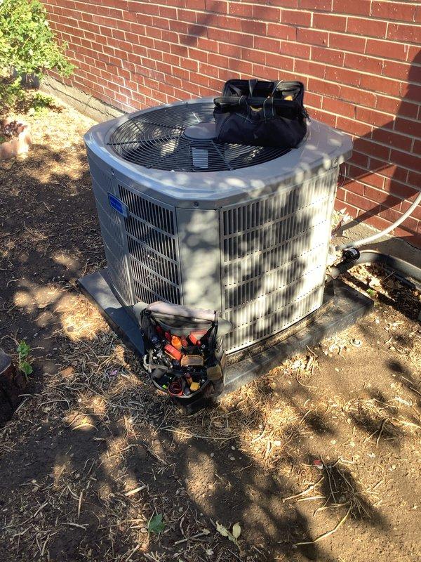 Completed preventive maintenance inspection on 2-year-old residential air conditioning unit located at side of garage. Performed standard tune-up procedures including voltage verification using digital multimeter, which confirmed proper electrical supply at 242.1 volts. Inspected outdoor condenser unit, compressor, electrical connections, and cooling fan operation. Unit equipped with washable filters, which were noted for homeowner maintenance. No reported issues or deficiencies found during inspection; system operating within normal parameters.