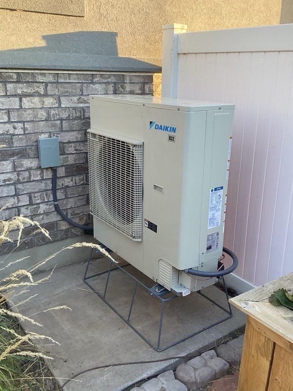 Completed full HVAC system installation including Daikin DR97MC0804CN furnace, CAPEA4830C3 outdoor condensing unit, and DH7VSA4210 air handler. Installed Daikin One thermostat for system control, mounted outdoor unit on elevated stand with snow legs for proper drainage and protection, and installed condensate pump (CCP) for moisture removal. All equipment tested and operational, system commissioned and verified for proper airflow and refrigerant charge.