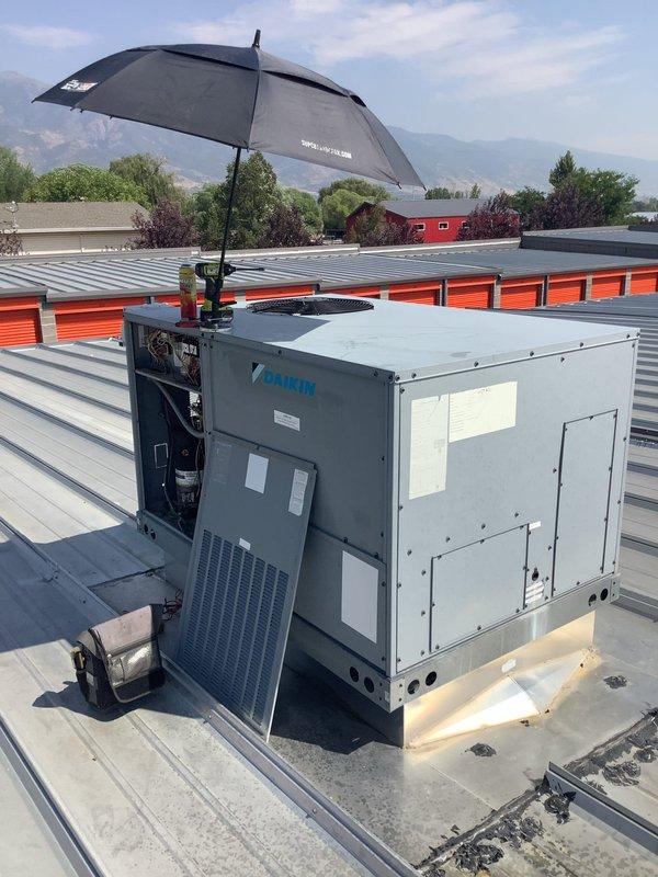Responded to service call for two rooftop HVAC units blowing warm air at commercial facility. Accessed Daikin rooftop package unit and identified refrigerant leak at brazed copper connections, evidenced by significant oxidation and discoloration at joints. Leak resulted in low refrigerant charge causing loss of cooling capacity. Repaired leak, pressure tested system, evacuated lines, and recharged unit to manufacturer specifications. Verified proper operation and adequate cooling restored to affected zones.