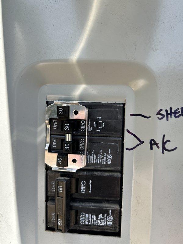 Responded to service technician referral for locked compressor that could not be repaired with hard start kit or field repairs. Inspected electrical panel and circuit breakers serving the air conditioning system, documenting 30-amp and 60-amp breaker configuration and circuit labeling. Photographed electrical distribution setup showing properly seated breakers and bus bar connections in preparation for system replacement estimate.