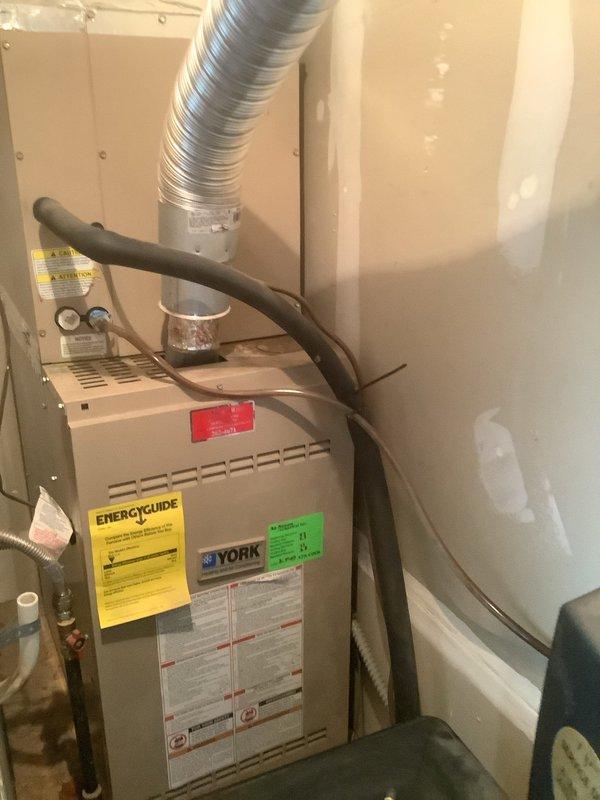 Responded to call for air handler leaking water with suspected condensate drain blockage on 10-15 year old York HVAC system located in mechanical closet. Upon arrival, confirmed air handler was operating but condensate was not draining properly through discharge line. Cleared clogged condensate drain line, verified proper drainage flow restored, and tested system operation to ensure no further leakage. Unit cooling normally with condensate now draining as designed.