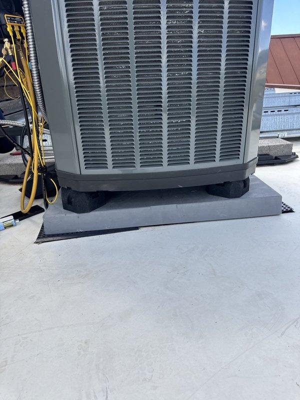 Returned to site to address and correct issues identified from initial installation. Inspected rooftop HVAC condenser unit and verified proper mounting on vibration dampening pads over membrane roofing. Checked refrigerant lines, electrical connections, and conduit routing for compliance with installation standards. Made necessary adjustments to ensure system operates according to manufacturer specifications and warranty requirements. Unit tested and confirmed operational.