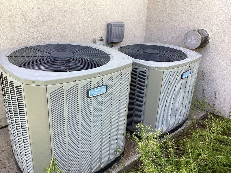 Conducted technical assessment and estimate for dual HVAC system replacement at residential property where existing furnaces were previously diagnosed with heat exchanger failures by another contractor. Documented model and serial numbers of both indoor furnace units and outdoor condensing units through comprehensive photography for potential repair consideration. Photographed internal components including condensate drainage system with PVC piping configuration, electrical connections, and copper refrigerant lines, as well as exterior dual condenser units mounted on concrete pad to provide complete system evaluation for replacement estimate comparison.