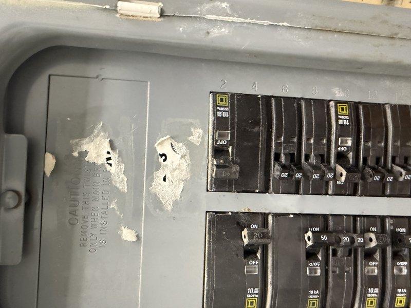 Responded to cooling complaint at restaurant location. Upon arrival, inspected rooftop/ground-level AC unit on south side of building. Found electrical panel serving HVAC equipment in severely deteriorated condition with significant corrosion, white residue buildup, and physical damage to panel door including multiple puncture holes. Circuit breakers showed signs of environmental exposure and debris accumulation. Panel condition indicated prolonged moisture intrusion and lack of maintenance, creating potential safety hazards and contributing to equipment performance issues. Documented extensive deterioration with photos for customer review and recommended immediate electrical panel replacement and professional evaluation of moisture source before further HVAC repairs can be safely performed.