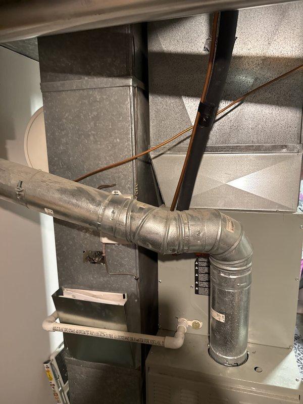 Responded to customer report of squeaking noise from 10-11 year old AC/furnace system in basement. Performed diagnostic inspection of HVAC equipment, including examination of furnace unit, ductwork connections, and Honeywell control components. Documented equipment condition with photos showing flexible ductwork, refrigerant lines, and electrical connections for estimate preparation.