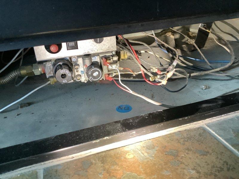 Responded to service call for gas fireplace insert repair. Accessed internal mechanical compartment and inspected gas control valve assembly, wiring connections, and pilot system components. Performed diagnostic evaluation and leveling check of control unit to ensure proper operation of the wall-mounted gas insert.