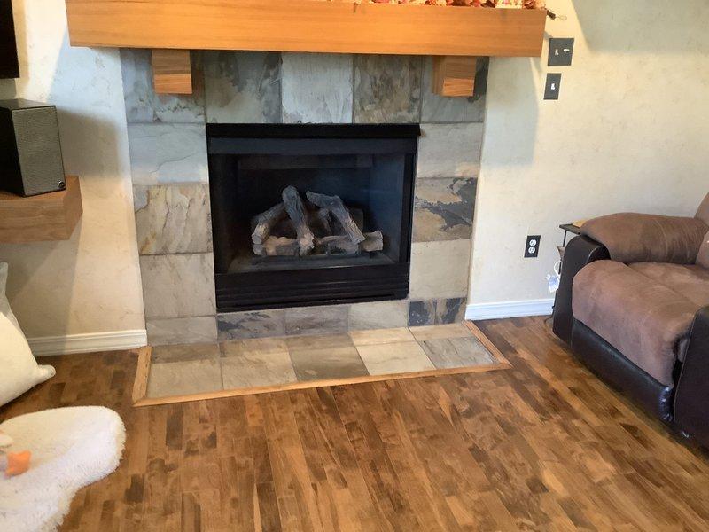 Completed routine maintenance and inspection on two gas fireplace units at residential property. The first unit, a see-through gas fireplace with decorative log set and stone tile surround, was thoroughly inspected with burner operation verified and flames observed burning properly with appropriate orange flame pattern and ember glow. The second unit, featuring a stone surround with mixed-pattern tile work and glass-front insert, was similarly inspected and serviced. Both fireplaces were cleaned, safety components checked, and confirmed to be operating within normal parameters. All glass panels, venting systems, and ignition controls tested and found functioning correctly.