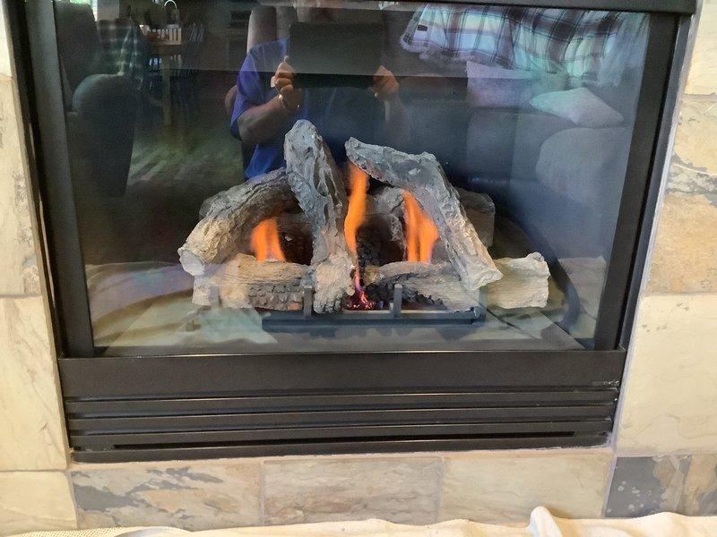 Completed routine maintenance and inspection on two gas fireplace units at residential property. The first unit, a see-through gas fireplace with decorative log set and stone tile surround, was thoroughly inspected with burner operation verified and flames observed burning properly with appropriate orange flame pattern and ember glow. The second unit, featuring a stone surround with mixed-pattern tile work and glass-front insert, was similarly inspected and serviced. Both fireplaces were cleaned, safety components checked, and confirmed to be operating within normal parameters. All glass panels, venting systems, and ignition controls tested and found functioning correctly.