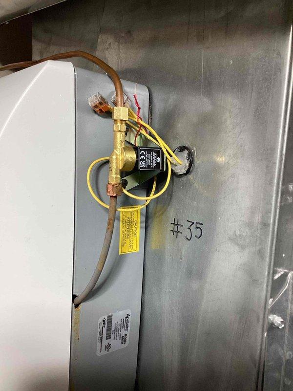 Installed AprilAire 24V solenoid valve (part #B14-314) on HVAC unit #35. Connected electrical wiring to solenoid coil and secured all plumbing connections with proper fittings and mounting hardware. Documented installation with photographs showing completed valve assembly and wire management.
