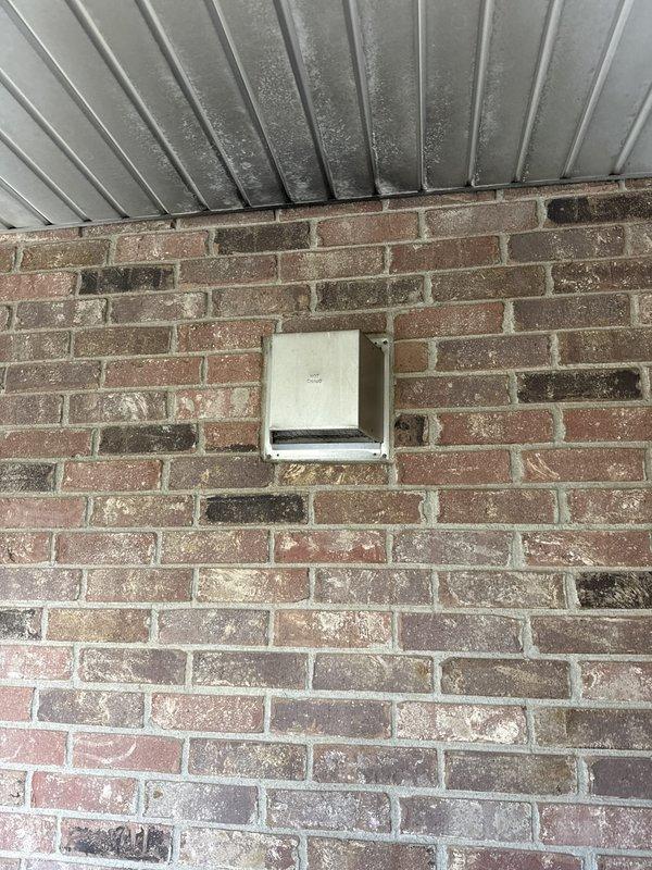 Conducted comprehensive fireplace replacement estimate for 26-year-old gas fireplace unit located on main floor. Evaluated existing installation featuring black speckled granite surround, brass trim, and slate hearth with current vented gas log system. Assessed exterior termination point through brick wall, noting existing vent hood condition and clearances. Provided technical specifications and recommendations for BX42 model replacement unit, including necessary modifications to existing surround, venting requirements, and compatibility with current installation footprint.