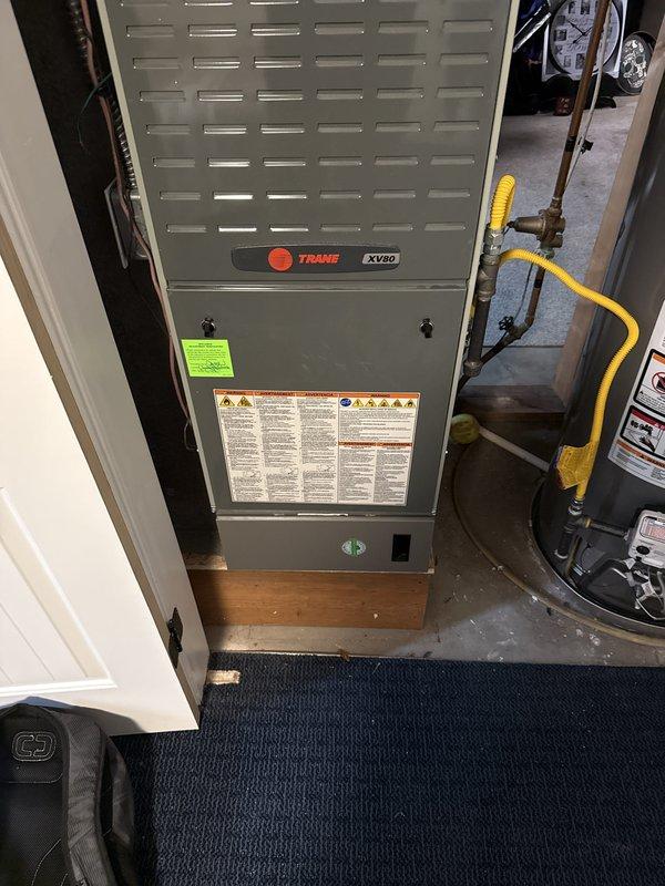 Conducted comprehensive equipment evaluation and estimate consultation for residential HVAC system replacement. Assessed aging 23-year-old Lennox air conditioning condenser unit located in exterior equipment well and 7-year-old Trane XV80 furnace with existing gas line configuration. Documented current system conditions through detailed photography, noting outdoor unit placement on concrete pad with refrigerant line routing and indoor furnace installation in utility closet with yellow gas piping. Discussed system replacement options and financing availability in preparation for anticipated equipment failure and upcoming price increases.