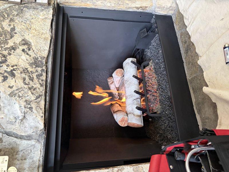 Completed standard maintenance and safety inspection on gas log fireplace that had not been serviced since original installation. Performed thorough cleaning of firebox interior, vacuumed debris and dust accumulation from around ceramic log set and burner assembly, and cleaned glass panels. Wiped down louvers and safety screens to remove dust buildup. Conducted full safety check including verification of proper gas flow, ignition system operation, and flame pattern. Tested all safety controls and confirmed unit was operating within manufacturer specifications with appropriate flame color and distribution across log set.
