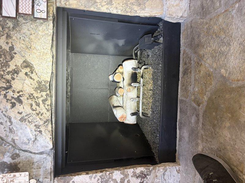 Completed standard maintenance and safety inspection on gas log fireplace that had not been serviced since original installation. Performed thorough cleaning of firebox interior, vacuumed debris and dust accumulation from around ceramic log set and burner assembly, and cleaned glass panels. Wiped down louvers and safety screens to remove dust buildup. Conducted full safety check including verification of proper gas flow, ignition system operation, and flame pattern. Tested all safety controls and confirmed unit was operating within manufacturer specifications with appropriate flame color and distribution across log set.
