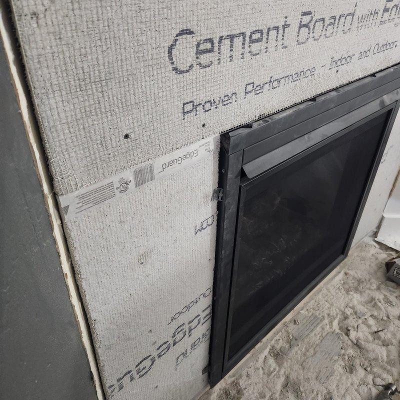 Responded to possible recall for unit BX36NTRE, PRPB36 with code 7449#. Inspected and documented installation of cement board material and ventilation components on exterior wall assembly. Verified proper mounting of dark-framed vent opening with mesh screen and confirmed cement board installation with visible fastener points and mesh reinforcement at seams. Photographed completed work showing building envelope system in construction phase for warranty and recall documentation purposes.
