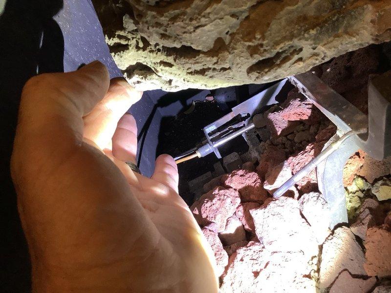 Performed comprehensive inspection and diagnostic evaluation of 1984 Alpine gas fireplace insert with black metal frame and glass doors. Assessed blower motor assembly for operational functionality and conducted thorough examination of gas line connections and venting system in crawl space beneath unit. Documented current condition of fireplace components including sooted glass doors, metallic control elements, and overall system performance. Provided technical assessment and recommendations for repair of existing unit, along with consultation regarding feasibility and requirements for installing a new direct vent fireplace system in an additional room without existing fireplace infrastructure.