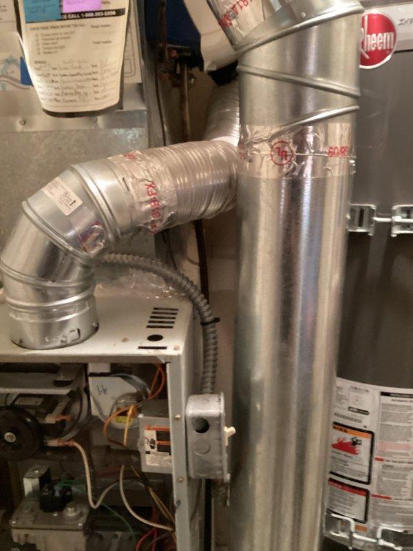 Responded to service tech referral for 21-year-old Carrier furnace system experiencing multiple component failures, including failing control board. Performed comprehensive system assessment and completed full heat loss calculations for replacement sizing, accounting for building envelope factors including wall insulation values, ceiling R-values, window configurations by orientation, door specifications, and infiltration loads. Documentation indicates required BTU input capacity of 70,000 BTU with total calculated heat load of 64,252 BTU after applying appropriate safety factors. Photographed existing equipment configuration showing Rheem ductwork connections, air handler internal components, and temporary flexible duct connections secured with tape, indicating system modifications or previous repair attempts.